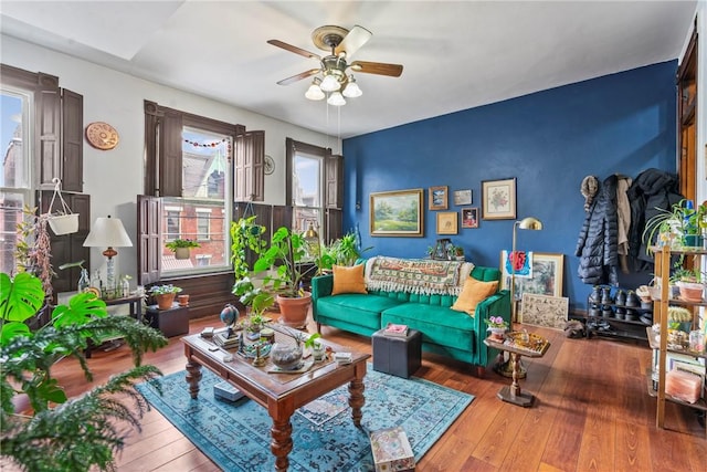 sitting room featuring ceiling fan and hardwood / wood-style flooring