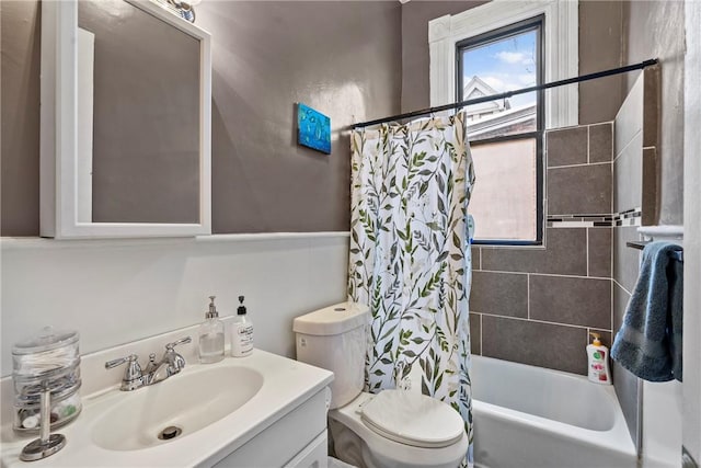 full bath with vanity, shower / tub combo, and toilet