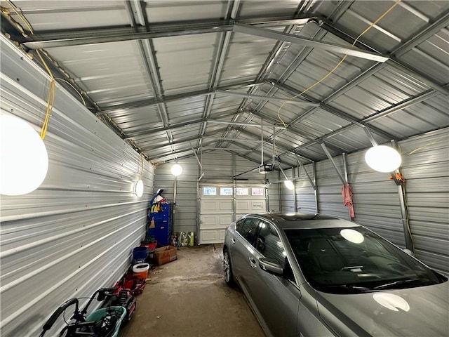 garage with a garage door opener and metal wall