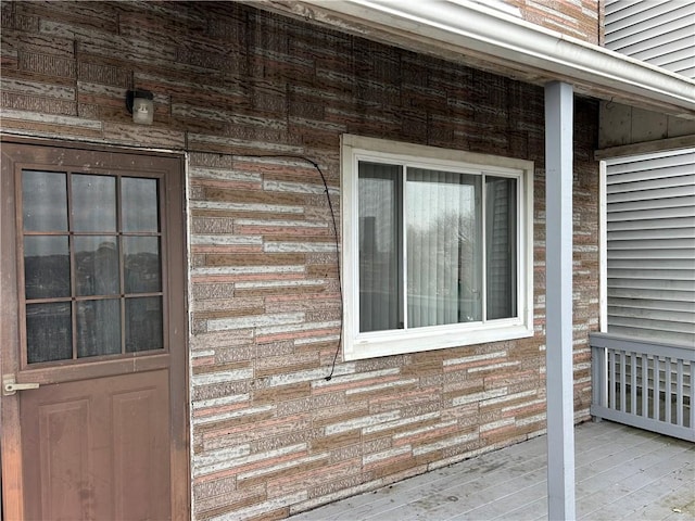 property entrance featuring brick siding