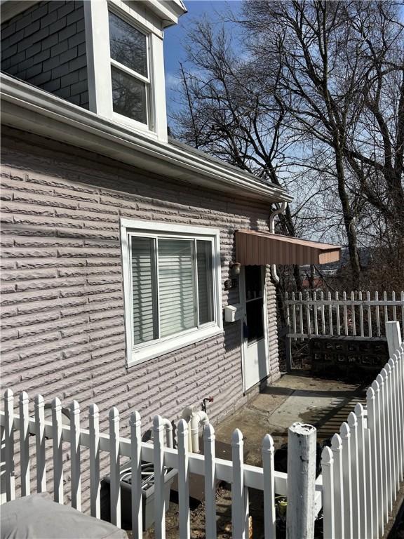 view of home's exterior with fence