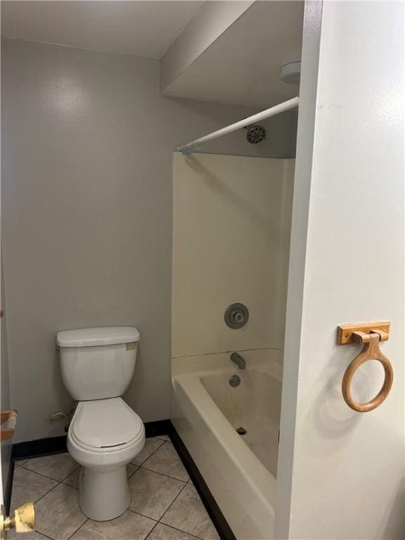 bathroom featuring tile patterned floors, toilet, baseboards, and  shower combination