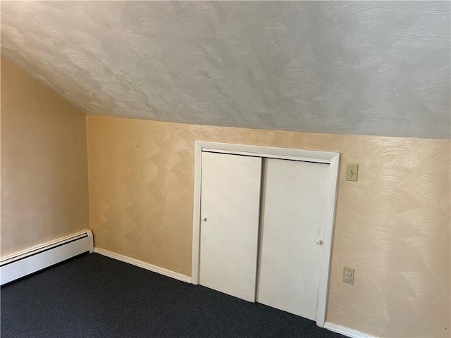 bonus room with a baseboard heating unit, a textured ceiling, carpet, baseboards, and vaulted ceiling