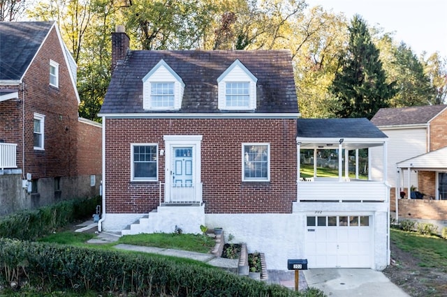 cape cod home with concrete driveway, a garage, brick siding, and a chimney