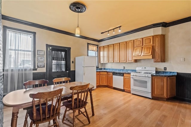 kitchen with wainscoting, white appliances, light wood-type flooring, and ornamental molding