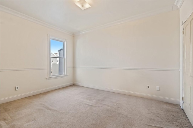 carpeted empty room with baseboards and ornamental molding