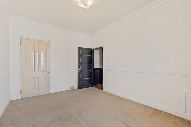 unfurnished bedroom with visible vents, ornamental molding, baseboards, and carpet floors