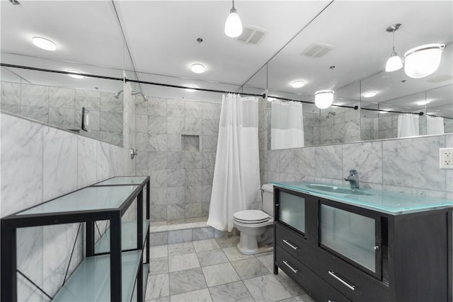 full bathroom featuring tile walls, visible vents, marble finish floor, and a tile shower