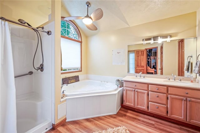 bathroom featuring lofted ceiling, a stall shower, and a sink