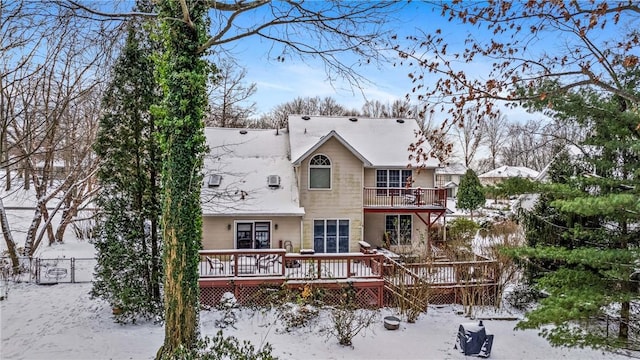 view of front of property with a wooden deck, a balcony, and fence