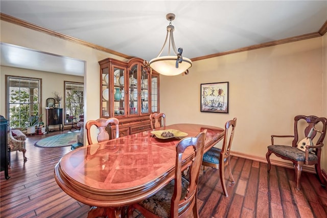 dining area with dark wood-type flooring, baseboards, and ornamental molding