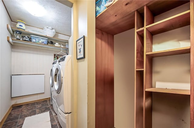 laundry room with laundry area, baseboards, and washer and clothes dryer