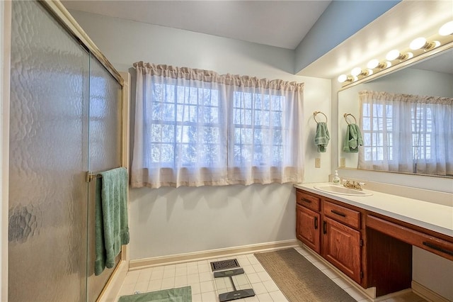 full bath featuring vanity, visible vents, baseboards, a shower stall, and tile patterned floors