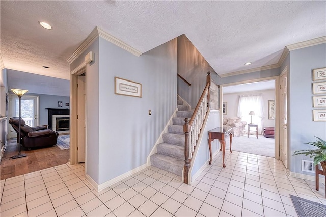 interior space featuring tile patterned floors, a fireplace, and crown molding