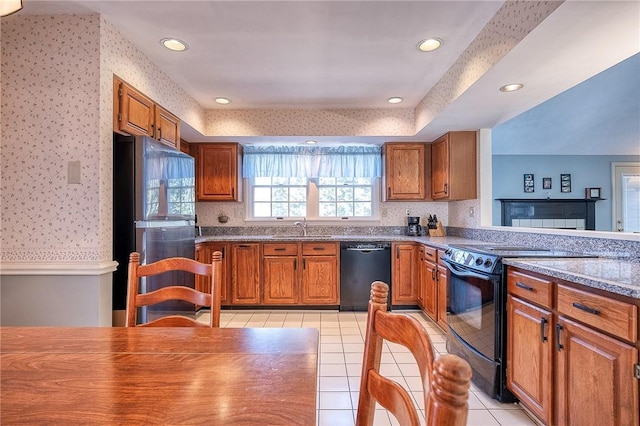 kitchen featuring wallpapered walls, black appliances, light tile patterned floors, and brown cabinetry