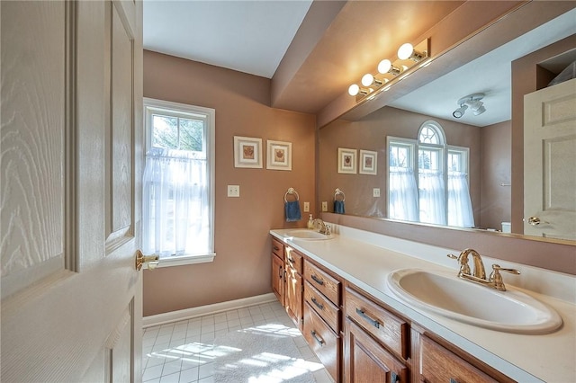 bathroom featuring a sink, a wealth of natural light, and tile patterned floors