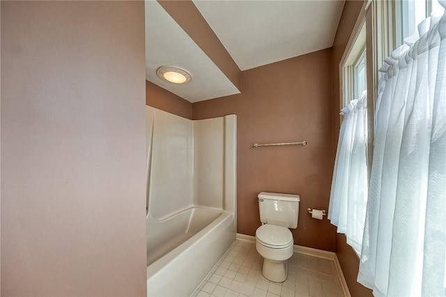 full bath with tile patterned floors, toilet, baseboards, and shower / washtub combination