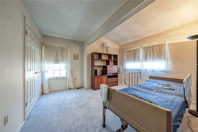 bedroom featuring carpet, baseboards, visible vents, lofted ceiling, and a textured ceiling