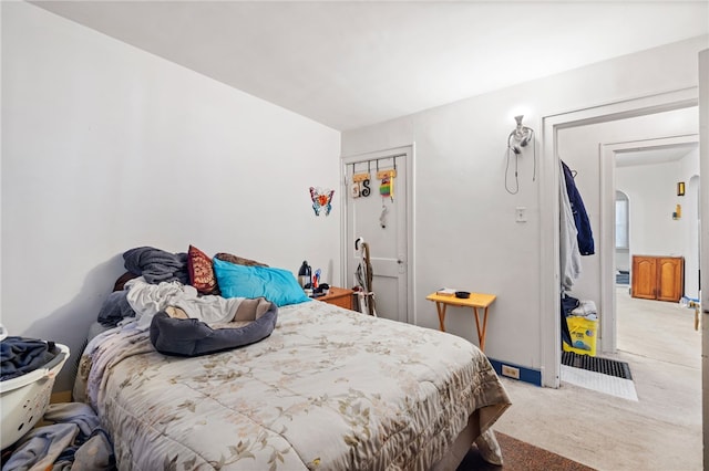 bedroom featuring carpet and arched walkways