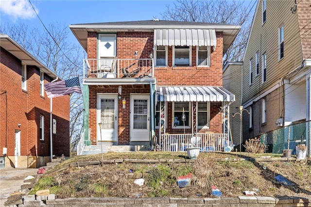 view of front of home with brick siding and covered porch