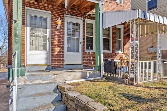 property entrance with brick siding