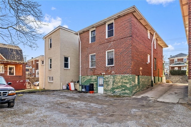 rear view of house featuring brick siding