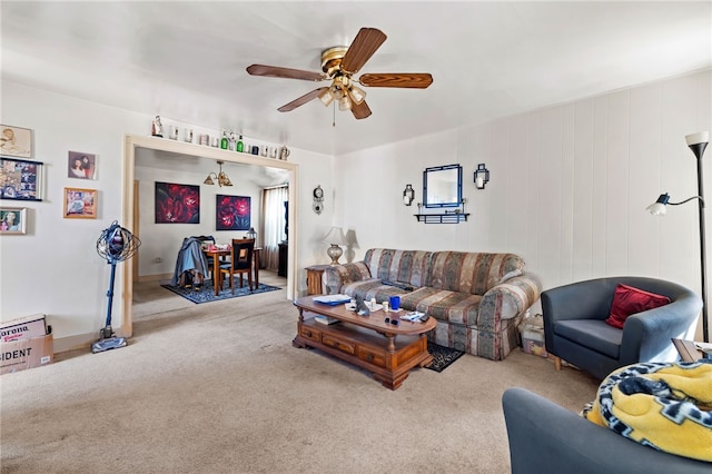 carpeted living room with a ceiling fan