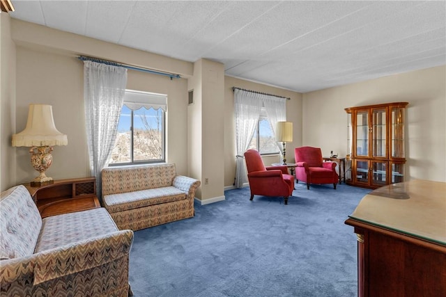 living area with plenty of natural light, carpet flooring, and baseboards