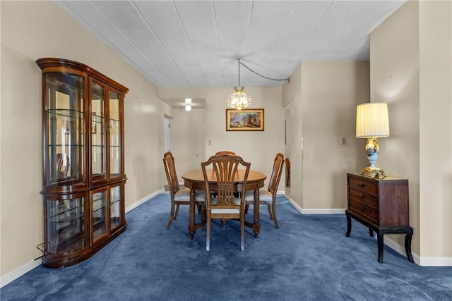 carpeted dining area with baseboards