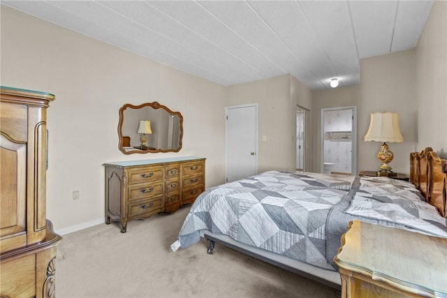 bedroom with light colored carpet and baseboards