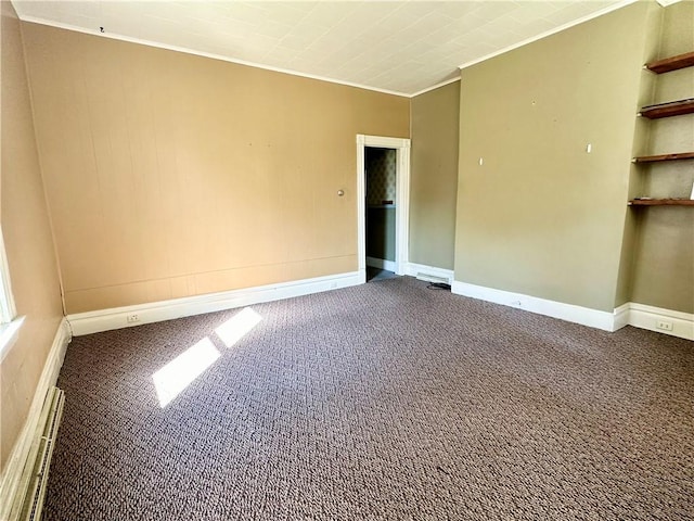 unfurnished room featuring a baseboard heating unit, baseboards, carpet, and crown molding