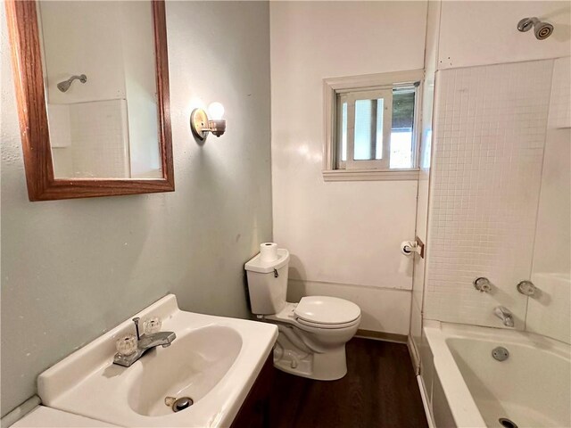 full bath with shower / washtub combination, toilet, vanity, and wood finished floors