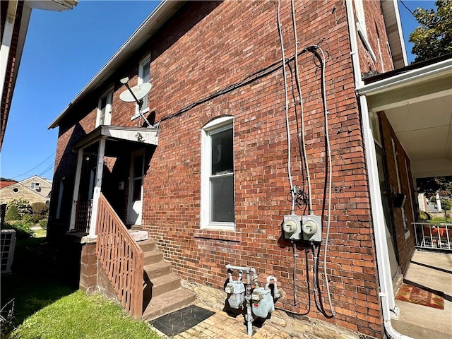view of side of property featuring brick siding