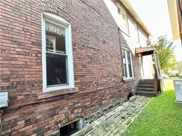 view of property exterior with brick siding