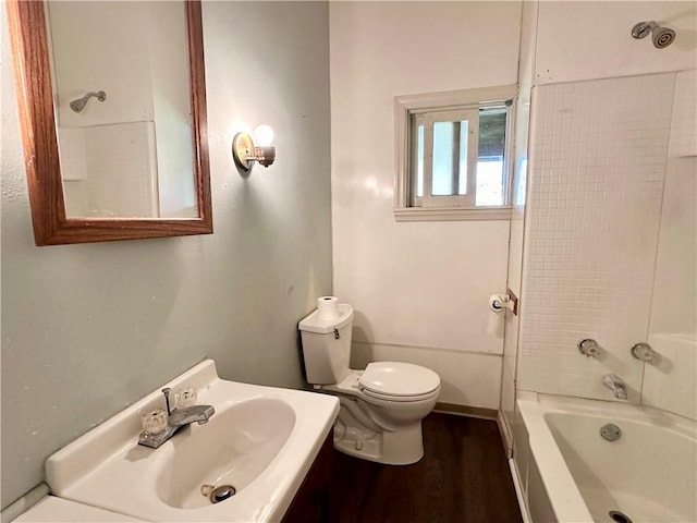 bathroom featuring vanity, shower / bathing tub combination, toilet, and wood finished floors