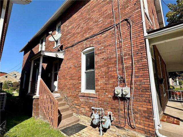 view of property exterior with brick siding