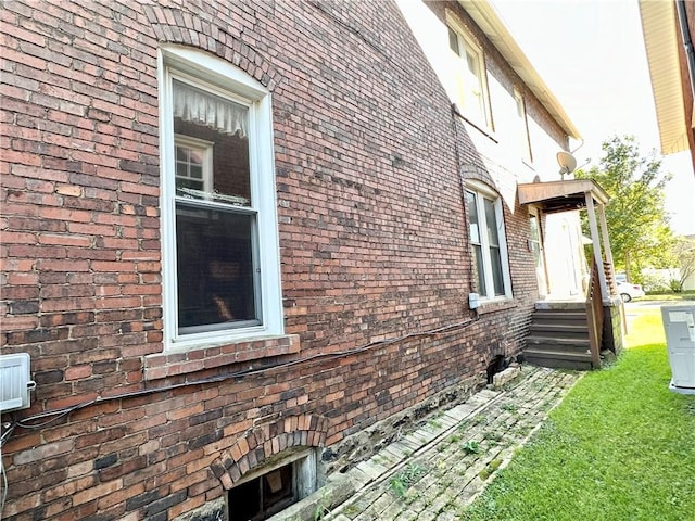 view of side of home with brick siding