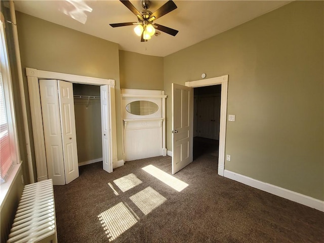 unfurnished bedroom with baseboards, carpet floors, and a ceiling fan