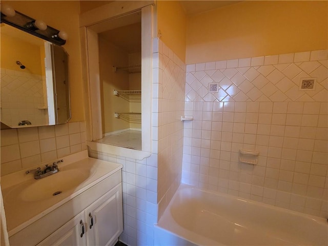 full bathroom with tub / shower combination, tile walls, and vanity