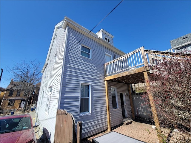 back of house featuring a wooden deck