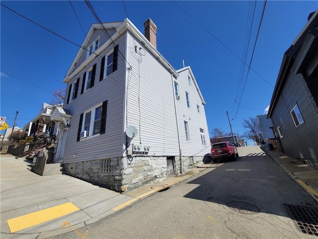 view of property exterior with a chimney