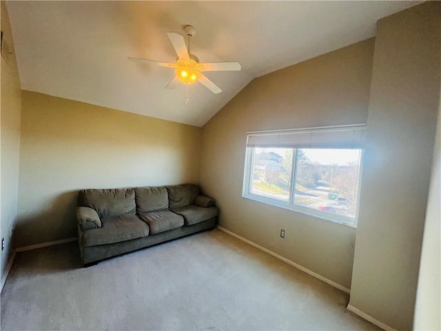 unfurnished living room featuring carpet floors, baseboards, a ceiling fan, and vaulted ceiling