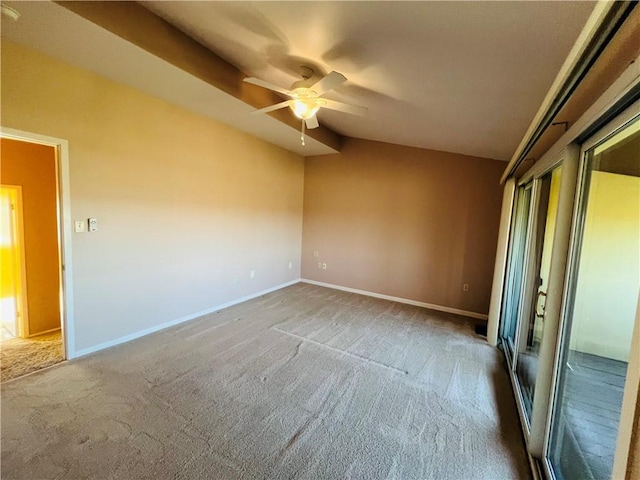 carpeted spare room featuring baseboards, ceiling fan, and vaulted ceiling