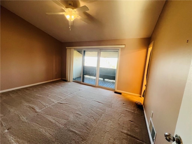 empty room featuring baseboards, visible vents, lofted ceiling, ceiling fan, and carpet flooring