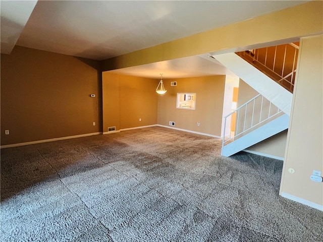 interior space with stairway, baseboards, carpet, and visible vents