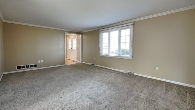 empty room with visible vents, baseboards, carpet flooring, and crown molding