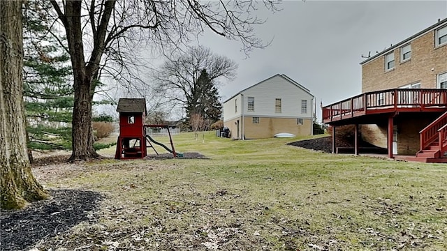 view of yard with a wooden deck and a playground