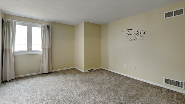 unfurnished room featuring visible vents, baseboards, and carpet