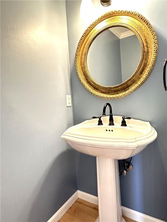 bathroom with baseboards and wood finished floors