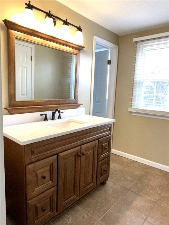 bathroom featuring vanity and baseboards